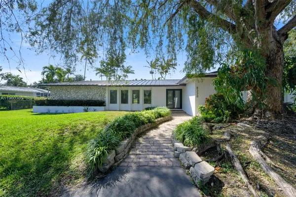 a front view of a house with a garden