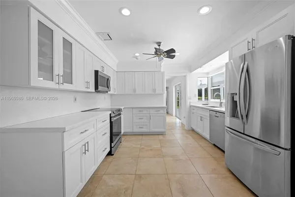 a kitchen with stainless steel appliances a refrigerator sink and microwave