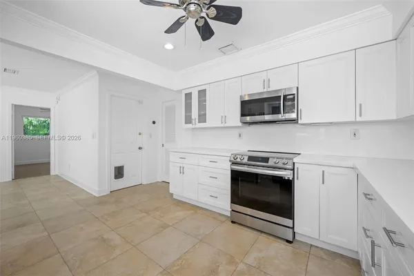 a kitchen with stainless steel appliances granite countertop a stove and a microwave