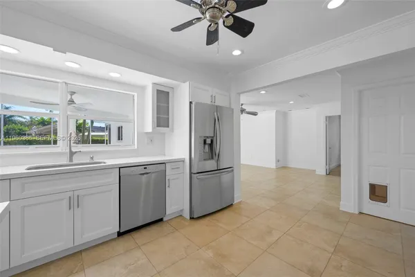 a kitchen with stainless steel appliances granite countertop a refrigerator and a sink