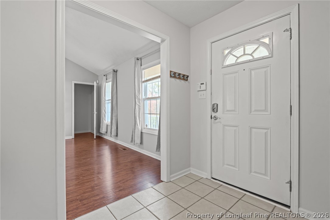 115 Shelby Street Spring Lake, NC 28390 - Photo 5 of 40 a view of an empty room with wooden floor and a window
