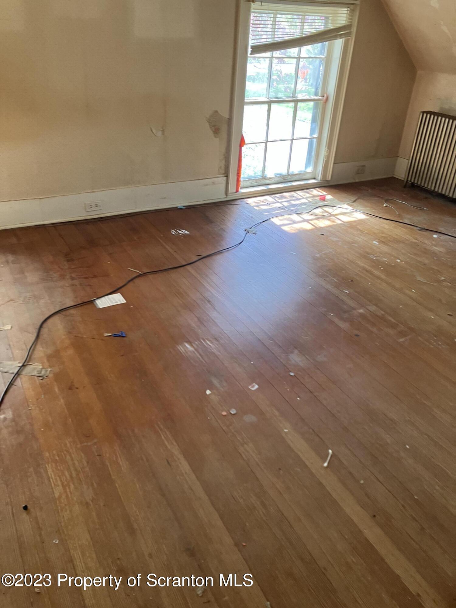 321 Maple Street Montrose, PA 18801 - Photo 27 of 28 an empty room with wooden floor and windows