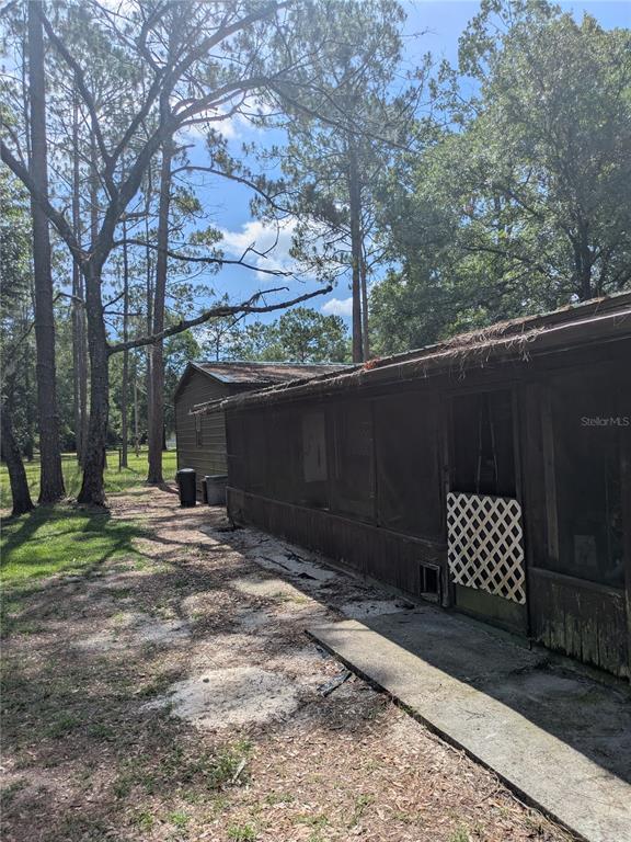 2833 Southwest Wilson Springs Road Fort White, FL 32038 - Photo 27 of 27 a side view of a house with a yard