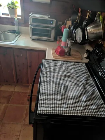 a kitchen with a sink and wooden cabinets