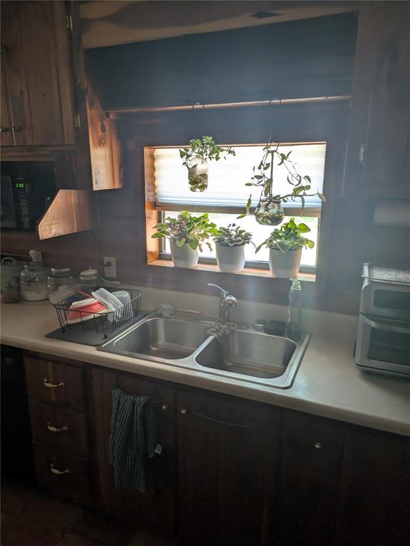 2833 Southwest Wilson Springs Road Fort White, FL 32038 - Photo 4 of 27 a kitchen with a sink and wooden cabinets