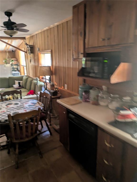 2833 Southwest Wilson Springs Road Fort White, FL 32038 - Photo 6 of 27 a kitchen with stainless steel appliances a stove a sink dishwasher and cabinets with wooden floor
