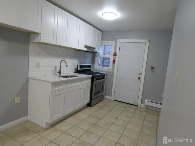 a kitchen with a sink cabinets and appliances