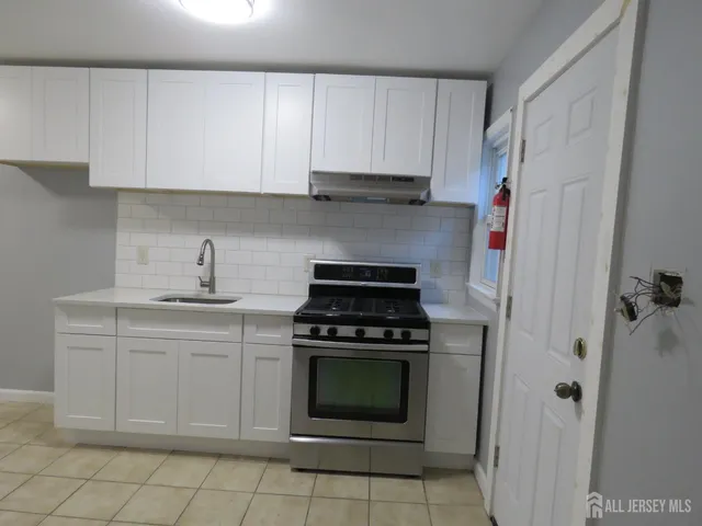 a kitchen with cabinets appliances and a sink