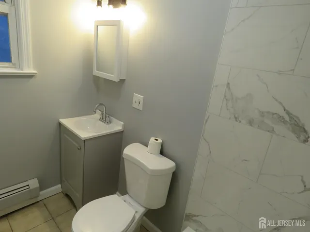 a white toilet sitting next to a bathroom sink