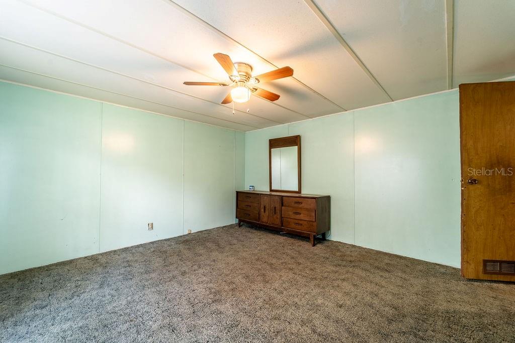 24031 Armadillo Road Astor, FL 32102 - Photo 34 of 43 an empty room with ceiling fan and window