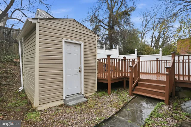 a view of a deck with a white roof and wooden fence