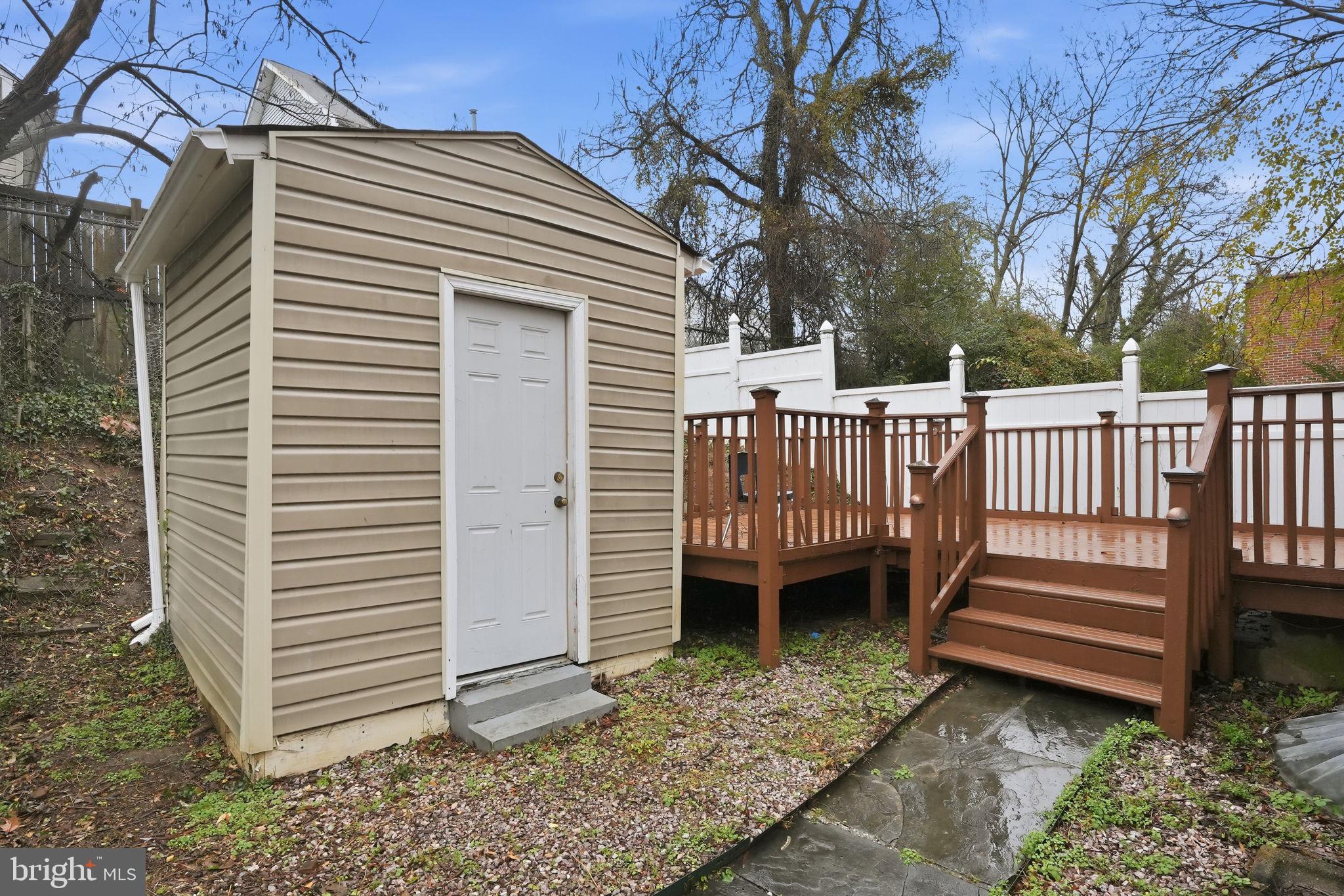 742 Congress Street Southeast Washington, DC 20032 - Photo 11 of 33 a view of a deck with a white roof and wooden fence