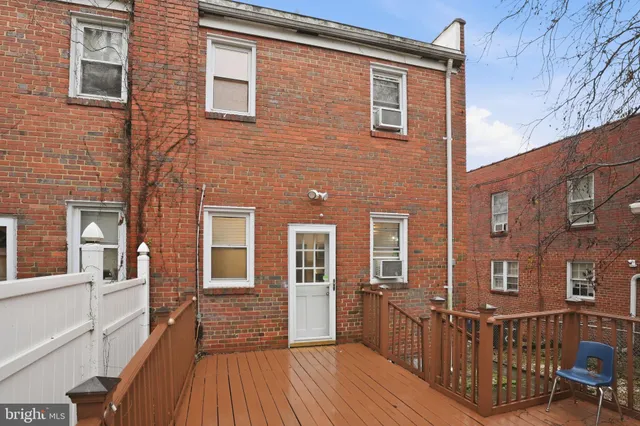a view of a brick house with many windows