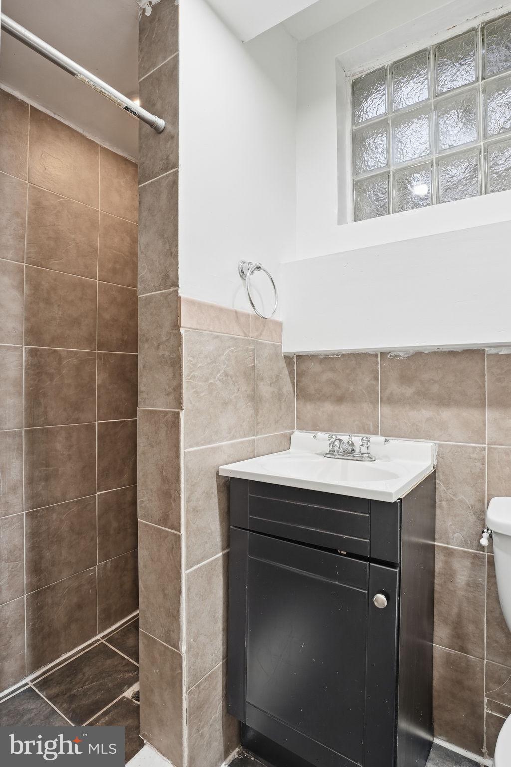 742 Congress Street Southeast Washington, DC 20032 - Photo 20 of 33 a bathroom with a sink a toilet and shower