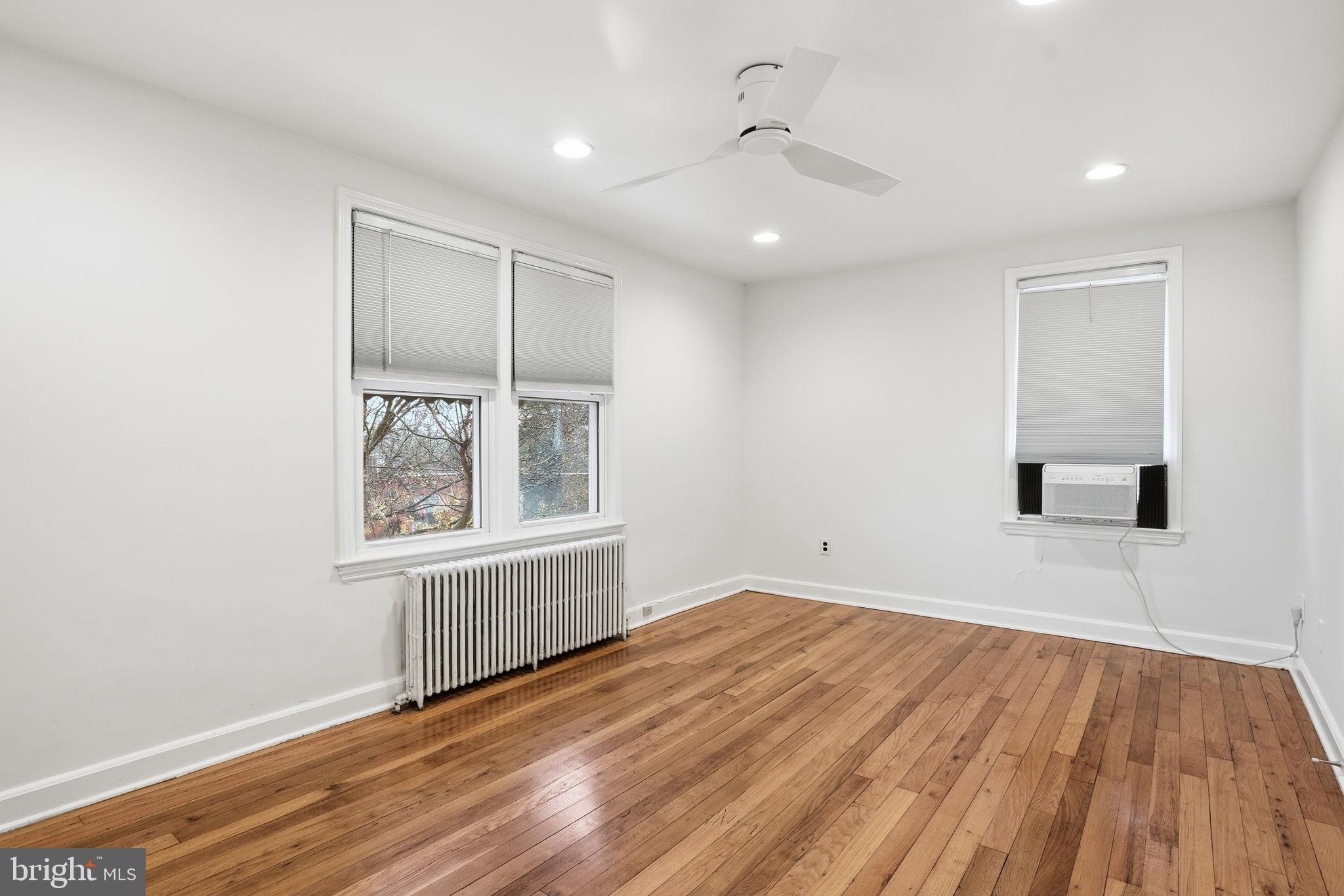 742 Congress Street Southeast Washington, DC 20032 - Photo 23 of 33 an empty room with wooden floor and windows