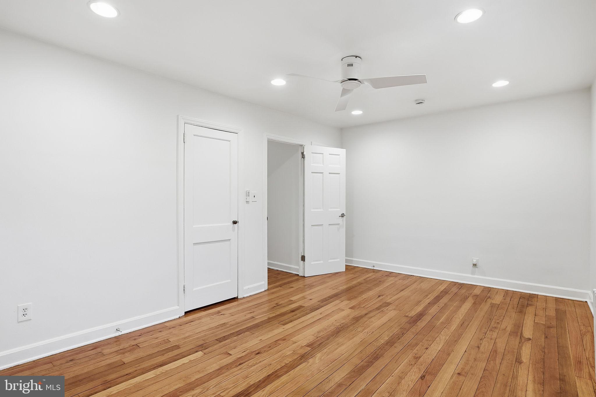 742 Congress Street Southeast Washington, DC 20032 - Photo 24 of 33 an empty room with wooden floor and windows