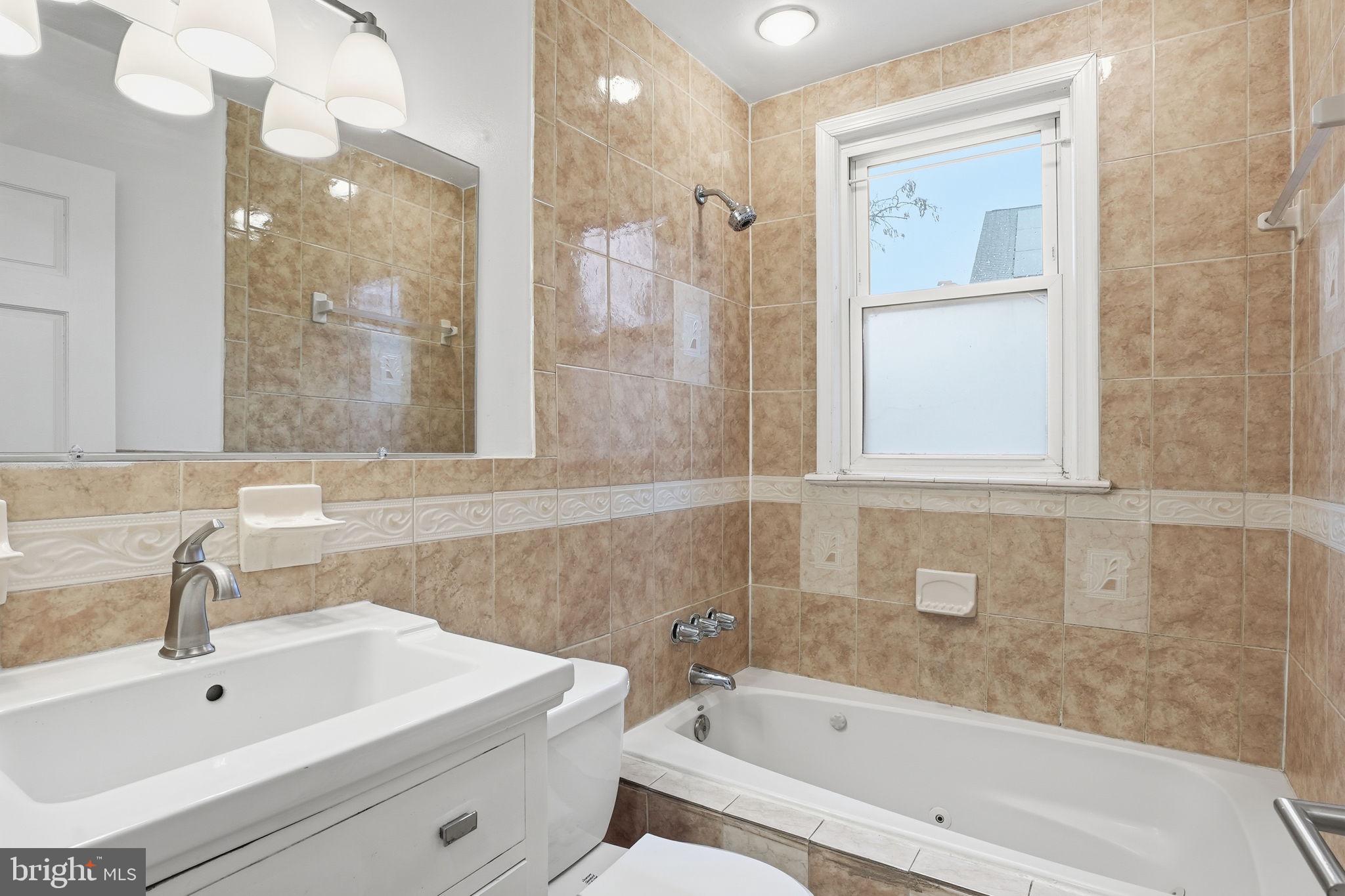 742 Congress Street Southeast Washington, DC 20032 - Photo 25 of 33 a bathroom with a bathtub and a sink