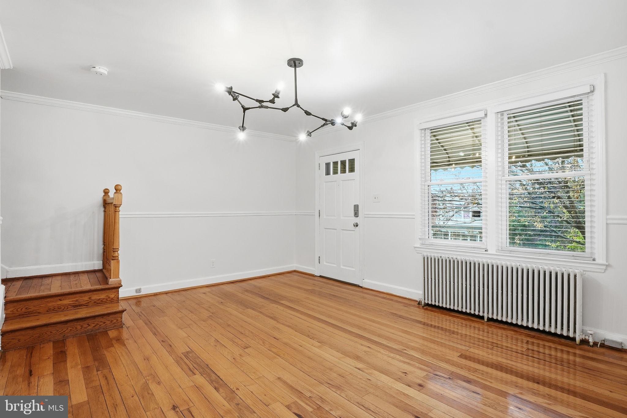 742 Congress Street Southeast Washington, DC 20032 - Photo 5 of 33 a view of an empty room with wooden floor and a window