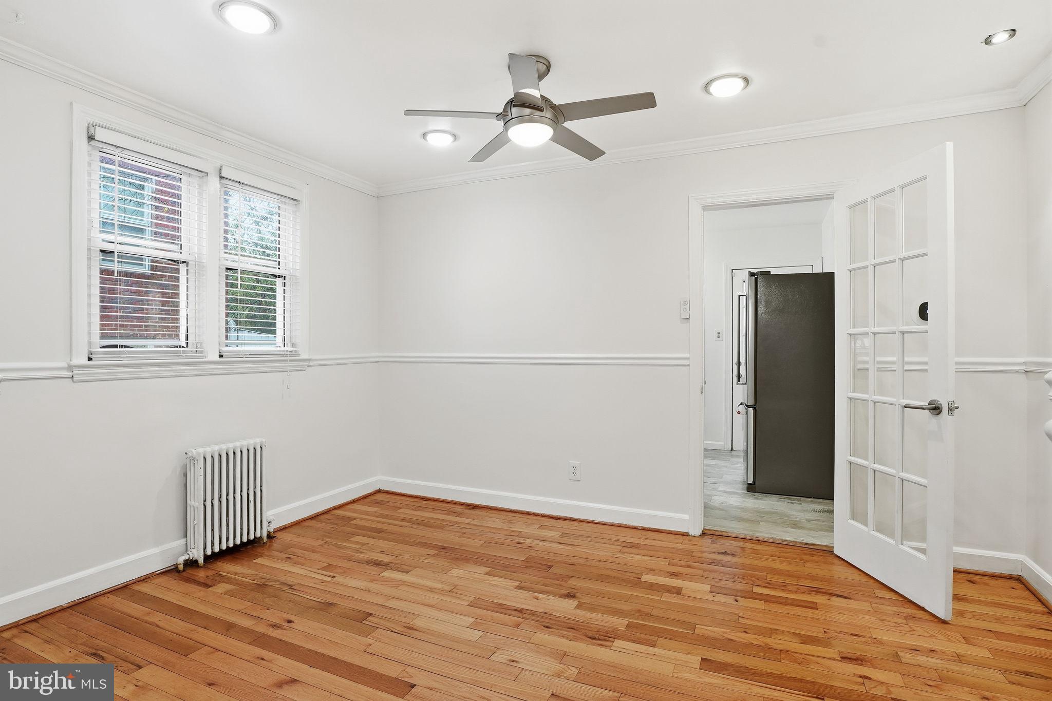 742 Congress Street Southeast Washington, DC 20032 - Photo 8 of 33 a view of an empty room with wooden floor and a window