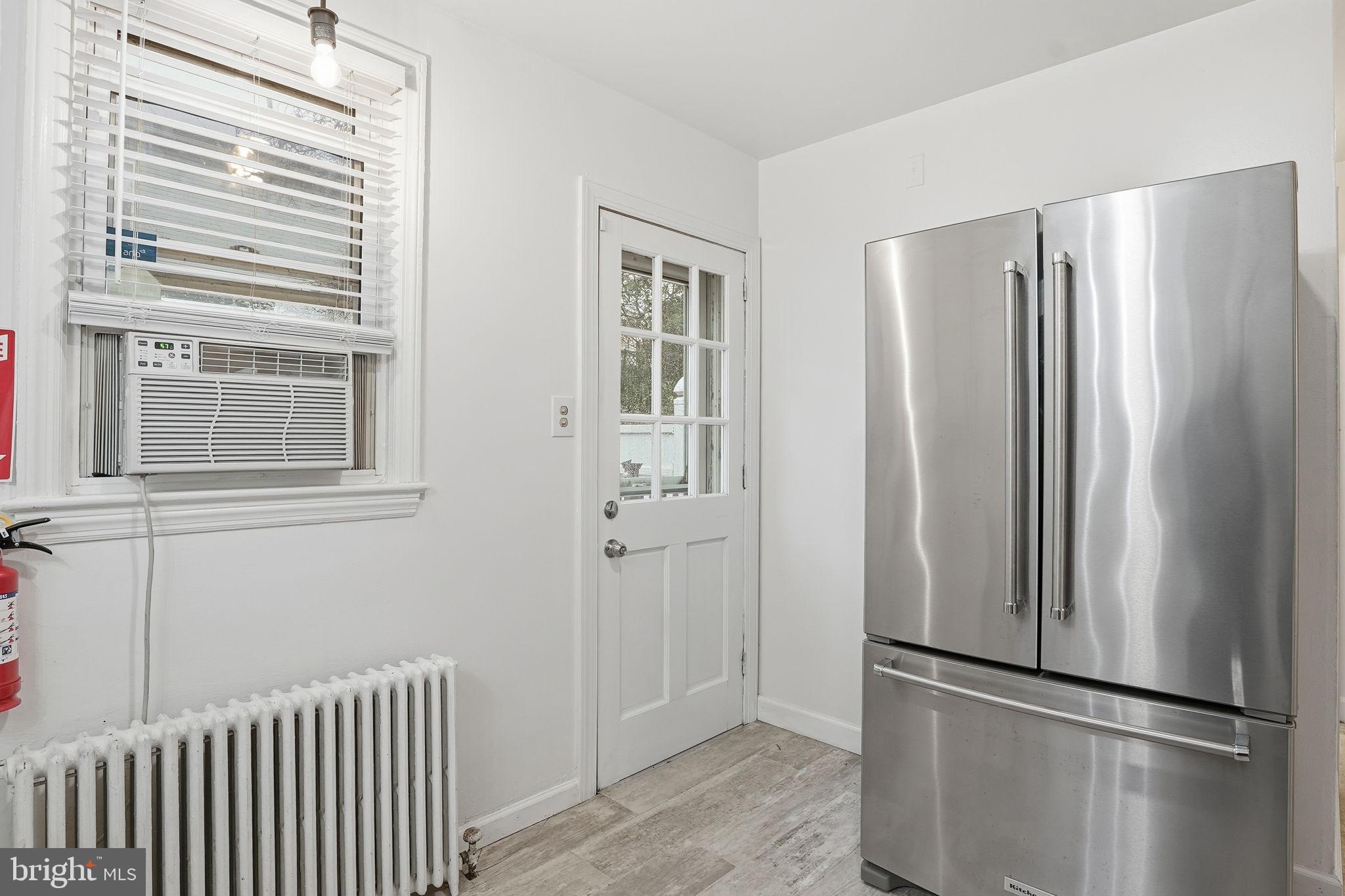 742 Congress Street Southeast Washington, DC 20032 - Photo 10 of 33 a view of kitchen with stainless steel appliances wooden floor and window