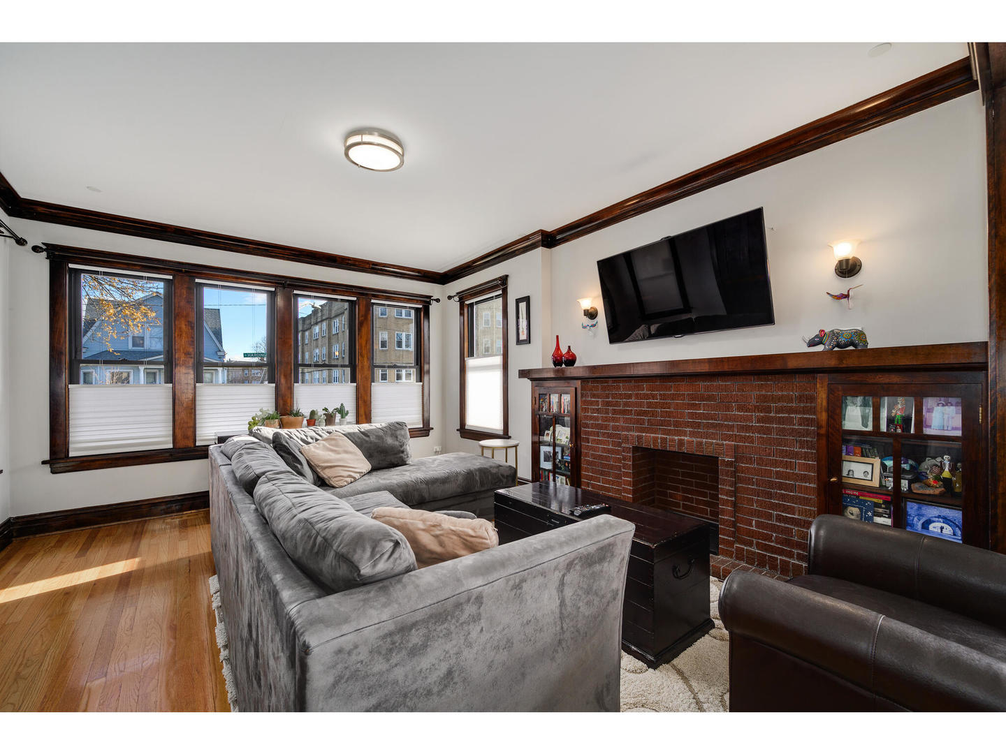 4500 North Harding Avenue Chicago, IL 60625 - Photo 5 of 29 a living room with furniture a flat screen tv and a fireplace