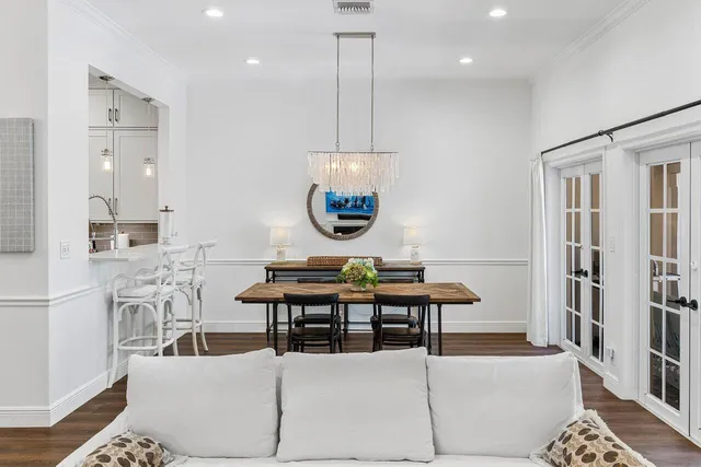 a living room with furniture a rug and a chandelier