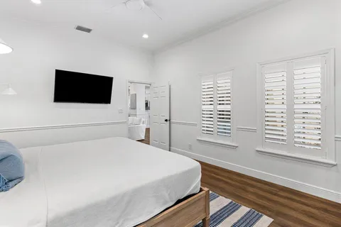 a bedroom with a large bed and a flat screen tv