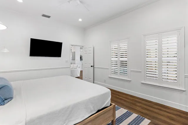 a bedroom with a large bed and a flat screen tv