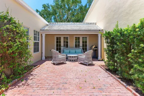 a view of a house with backyard sitting area and garden
