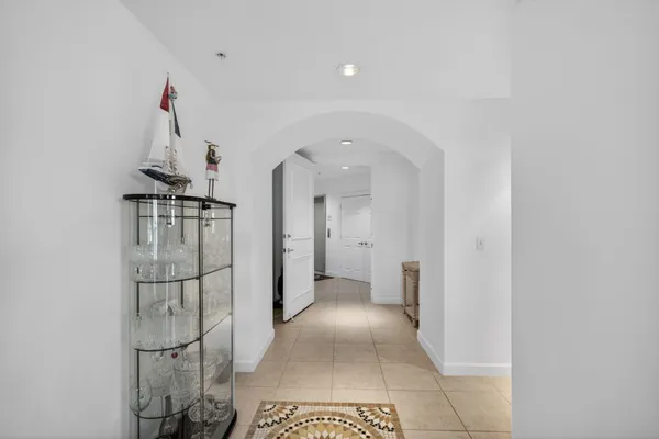 a living room with furniture a flat screen tv and kitchen view