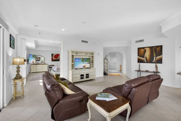 a kitchen with stainless steel appliances granite countertop a stove top oven a sink a dining table and chairs