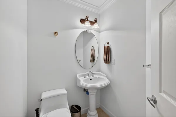 a bathroom with a sink a toilet and a mirror
