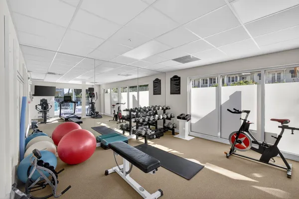 a street view with a lake and houses in the back