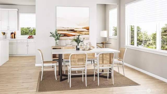 a dining room with furniture large windows and wooden floor