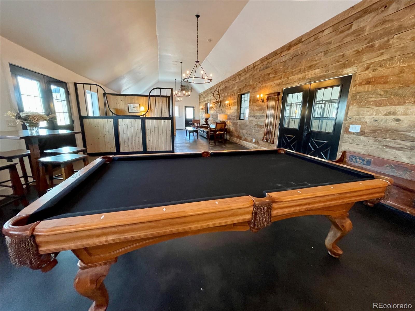 26794 Maul Road Elbert, CO 80106 - Photo 13 of 44 wooden floor with pool table and windows