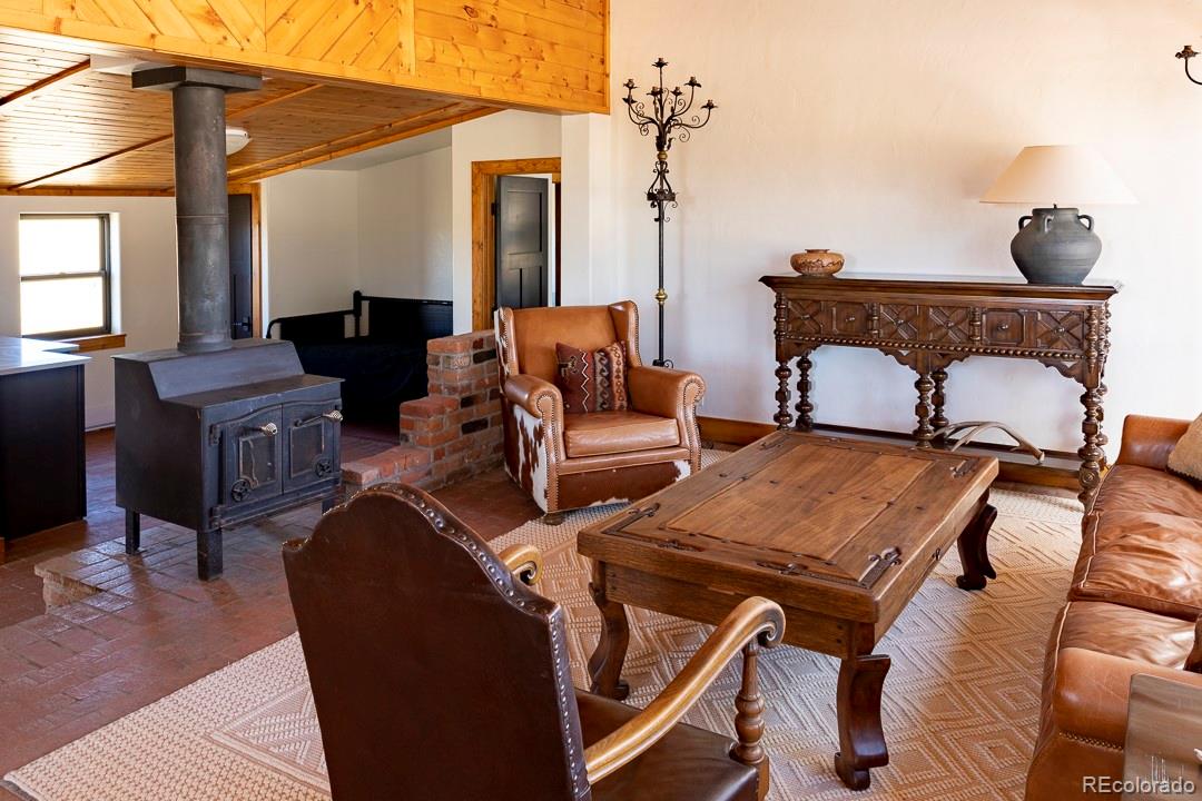 26794 Maul Road Elbert, CO 80106 - Photo 20 of 44 a living room with furniture and a chandelier