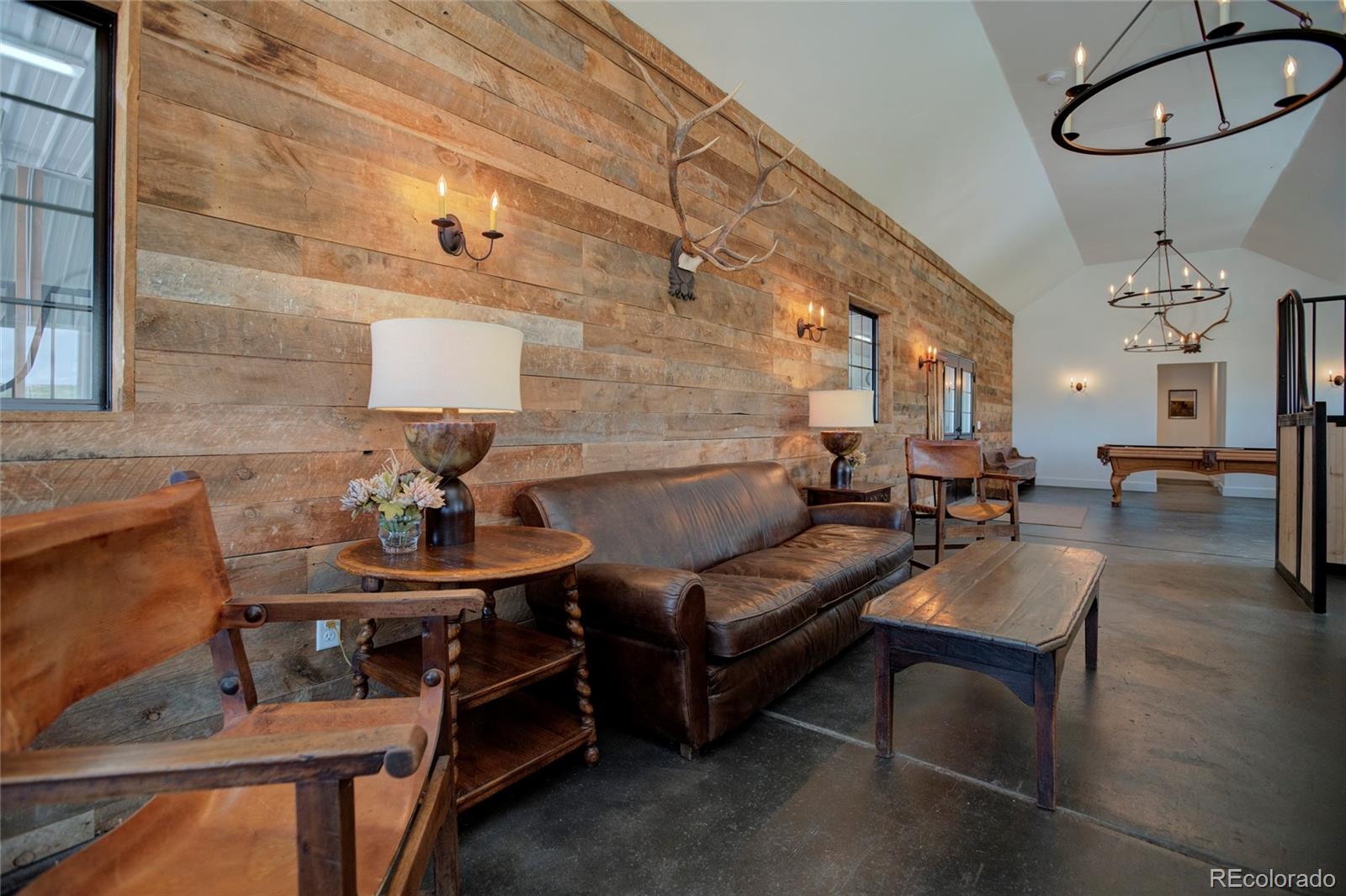 26794 Maul Road Elbert, CO 80106 - Photo 36 of 44 a living room with furniture a table and wooden floor