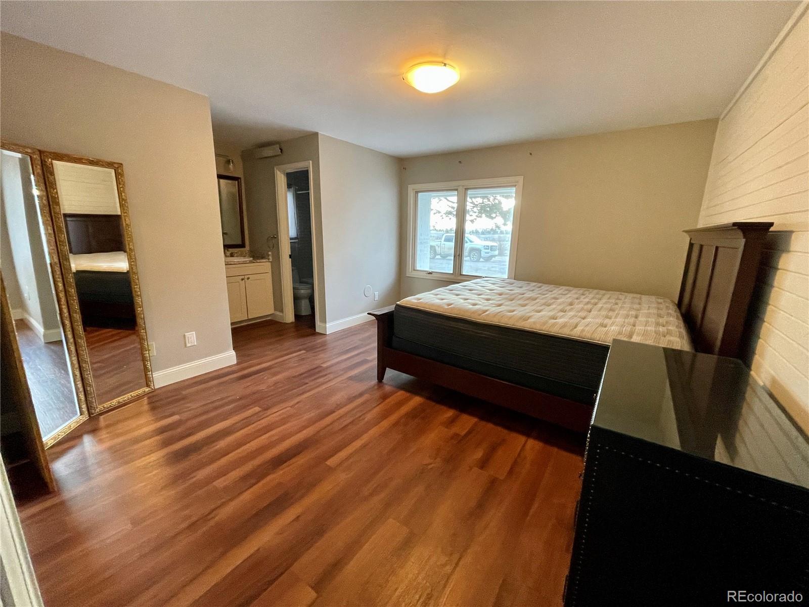 26794 Maul Road Elbert, CO 80106 - Photo 6 of 44 a bedroom with a bed and wooden floor