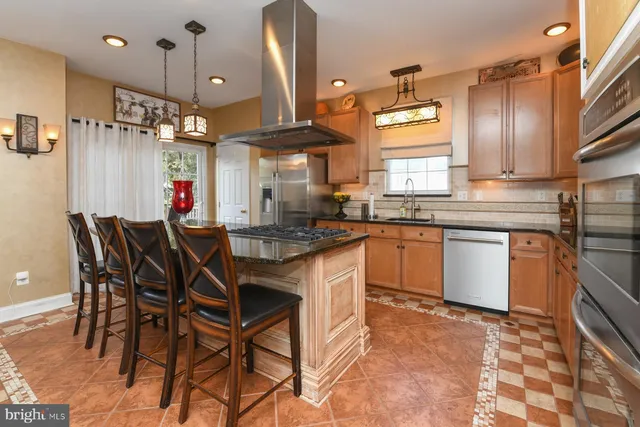 a kitchen with a table chairs stove and cabinets