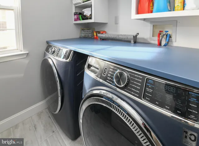 a view of a kitchen with workspace and furniture