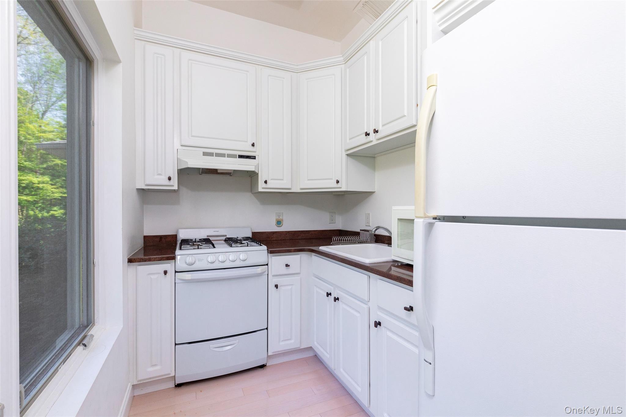 126 Old Hopewell Road Wappingers Falls, NY 12590 - Photo 27 of 38 a kitchen with white cabinets and white appliances