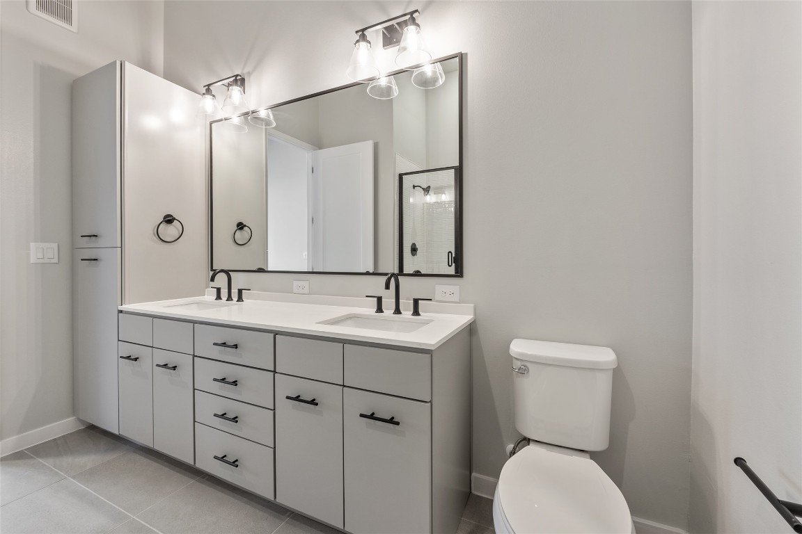 4510 Terry-O Lane, Unit 141 Austin, TX 78745 - Photo 11 of 29 Full bath featuring a shower stall, visible vents, a sink, and toilet