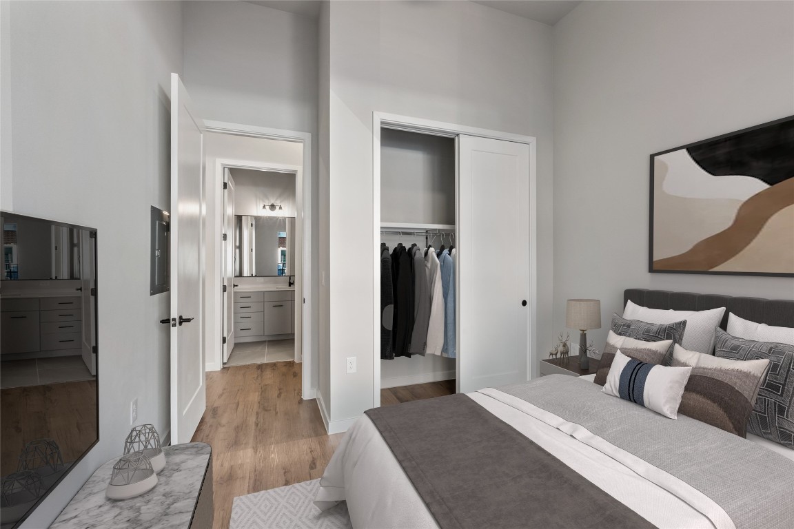 4510 Terry-O Lane, Unit 141 Austin, TX 78745 - Photo 15 of 29 Bedroom featuring a closet, light wood finished floors, and a towering ceiling