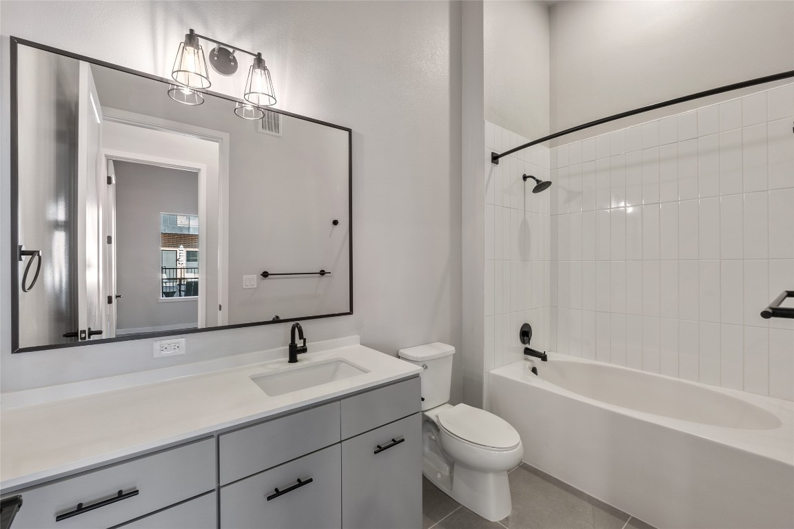 4510 Terry-O Lane, Unit 141 Austin, TX 78745 - Photo 16 of 29 Bathroom featuring vanity, tile patterned flooring, toilet, visible vents, and bathtub / shower combination