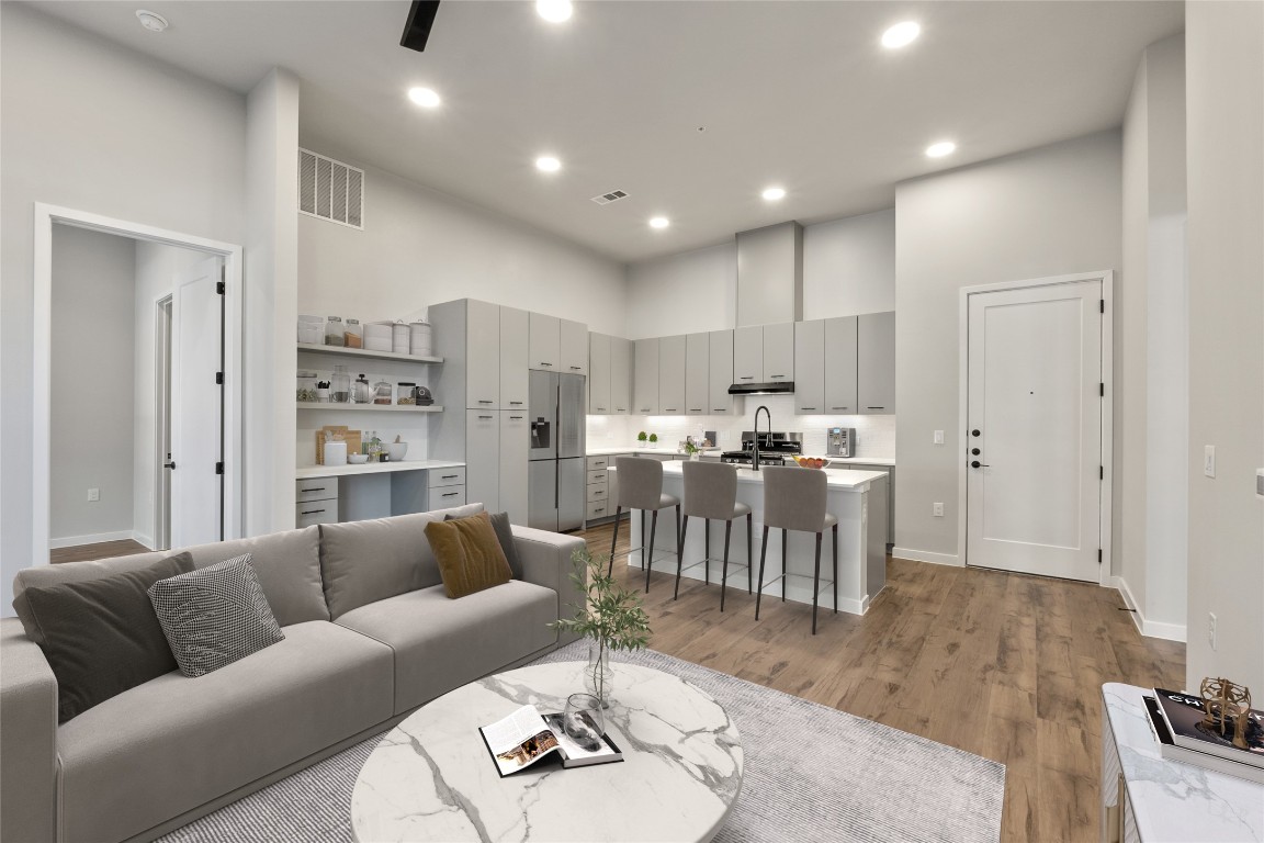 4510 Terry-O Lane, Unit 141 Austin, TX 78745 - Photo 6 of 29 Living room featuring visible vents, recessed lighting, a high ceiling, and wood finished floors