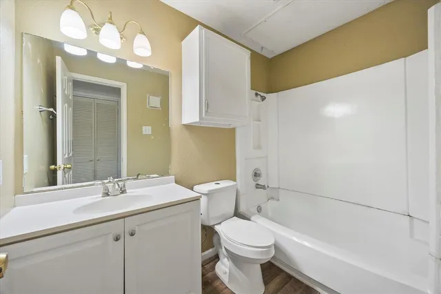 a bathroom with a sink a toilet and bathtub