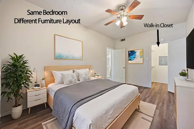 a bedroom with bed and a potted plant