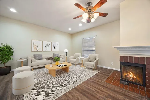 a living room with furniture a fireplace and a potted plant