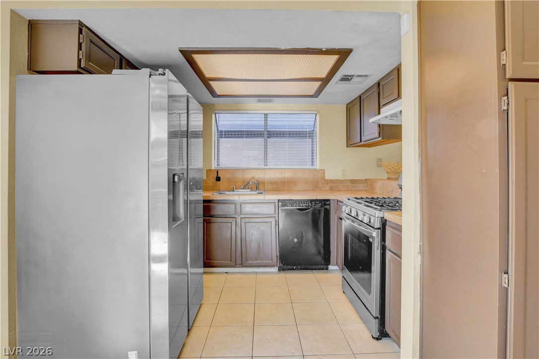 6440 Hartwood Road Las Vegas, NV 89108 - Photo 18 of 59 A well-appointed kitchen features tile flooring and ample cabinet storage.
