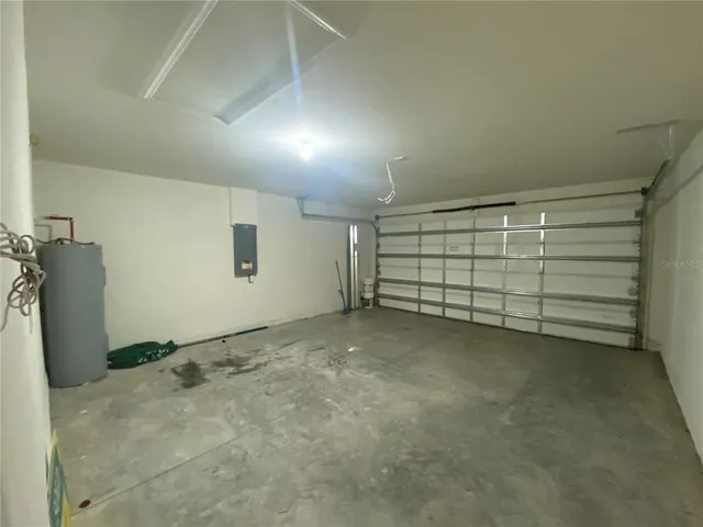 a view of a kitchen with refrigerator and windows